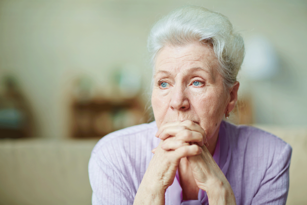 Common-Signs-of-Anxiety-in-Older-Adults woman looks out window and considers the signs of anxiety in older adults