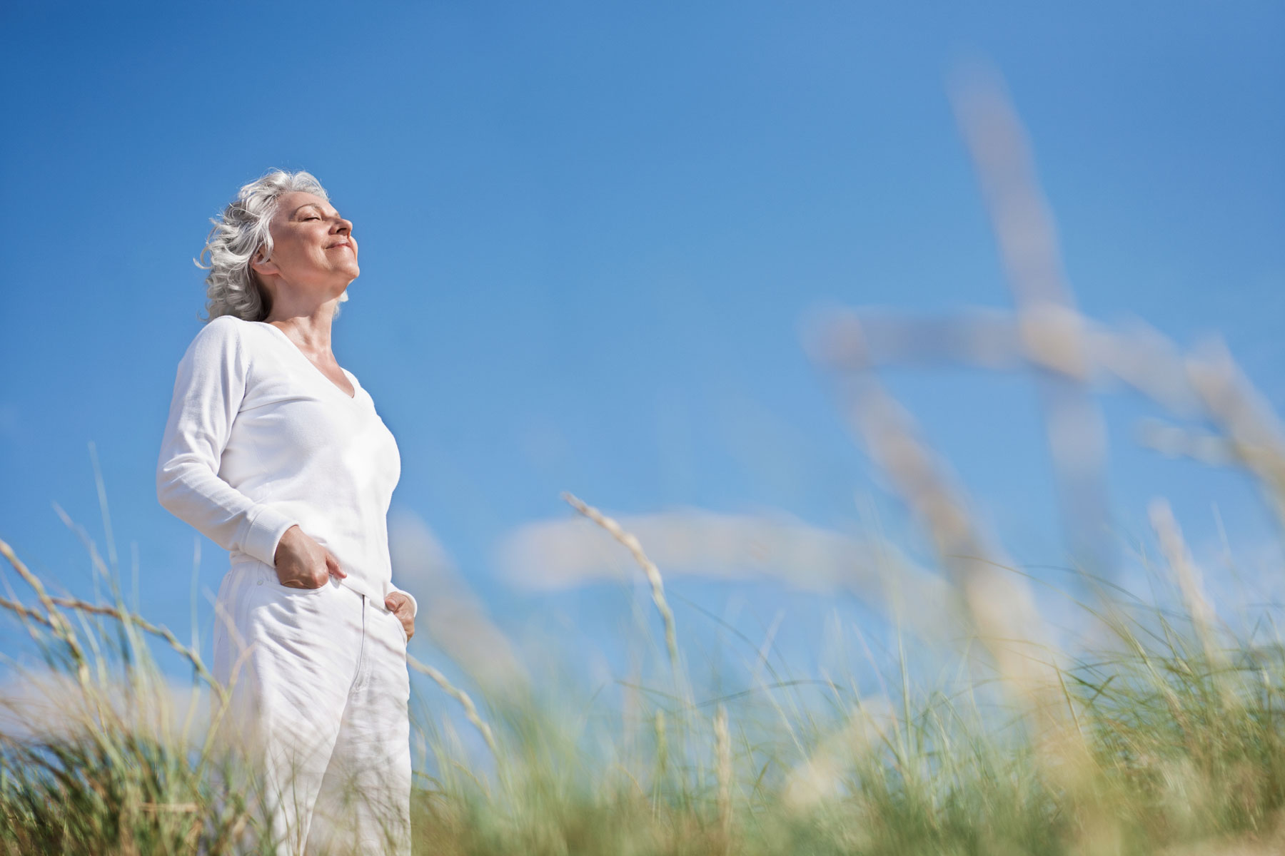5 Benefits of Holistic Health and Wellness Activities a senior woman enjoys time in nature