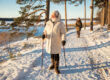 seniors in independent living take a snowy winter walk with walking aids for extra safety