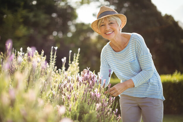 Understanding Your Senior Living Options a senior woman tends to her garden after exploring her senior living options and making the best choice for her