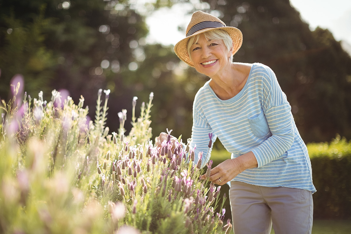 Understanding Your Senior Living Options a senior woman tends to her garden after exploring her senior living options and making the best choice for her