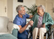 a caregiver checks on a senior in an assisted living community